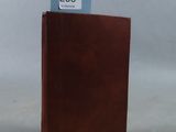 a brown book that has a blue label on it