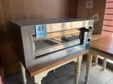 an oven that is sitting on a table in a room