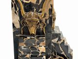 statue of a bull head on a marble base with gold accents