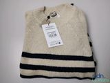 a close up of a sweater with a tag on it