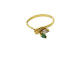 a close up of a gold ring with a green stone