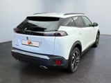 the rear end of a white suv parked in a room
