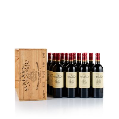 six bottles of wine in a wooden box with a wooden box behind them