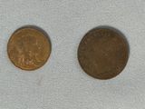 two coins sitting next to each other on top of a blue cloth