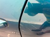 a reflection of a person in the side mirror of a car