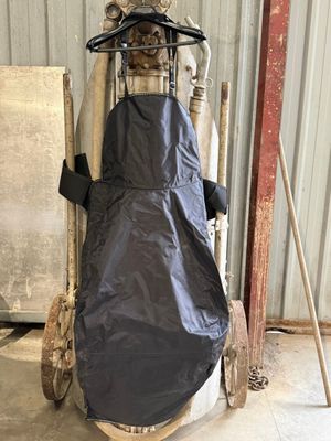 a black cover on the back of a cart in a warehouse