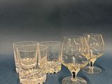 three wine glasses sitting on top of a table next to each other