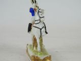 a figurine of a man riding on a horse