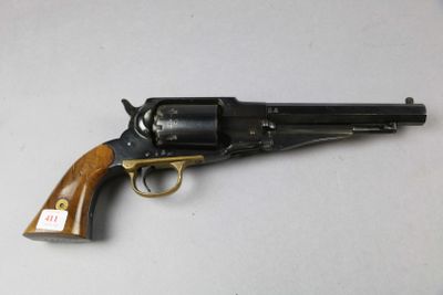 a close up of a revolver with a wooden handle on a white surface