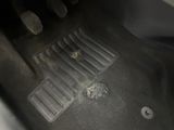 a car floor with a dirty floor mat on it