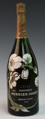 a bottle of champagne with a floral design on it