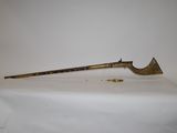 a long wooden stick on a table with a white cloth