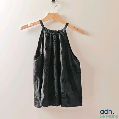 an image of a black dress hanging on a hanger