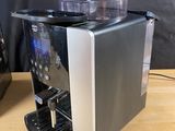 the coffee machine is sitting on a wooden table next to a cup holder