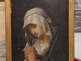 un tableau représentant une femme tenant un bébé dans ses bras, dans un cadre doré