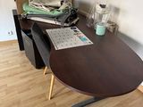 a desk with a chair and a computer on it