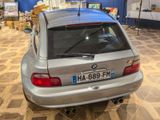 a silver car that is parked in a showroom