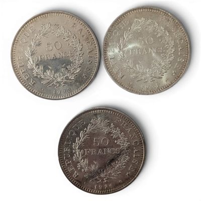 three different types of coins are shown on a white surface