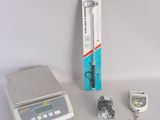a small electronic scale sitting on a table next to other items