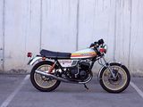 a motorcycle parked in a parking lot next to a wall