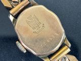 an image of a close up of a wrist watch on a black surface