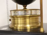 a black and gold clock sitting on top of a table