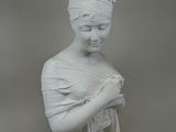 white marble bust of a woman with a turban on her head