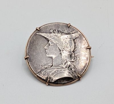 an image of a silver coin with a woman ' s face on it