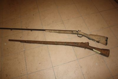 two guns that are on the floor next to each other