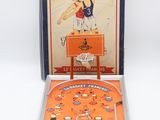 an orange pinball machine with a basketball game in it
