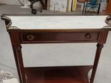 a table with a marble top and a shelf on it