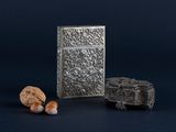 an old silver box and a rock on a blue background