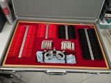 a suitcase that has many different types of hair brushes in it