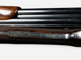 a close up of a shotgun with a wooden handle on a white background