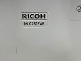 a close up of a ricoh machine on a table