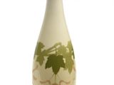 un vase blanc orné de feuilles vertes sur fond blanc