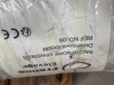 a large roll of white paper on a pallet in a warehouse