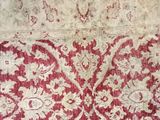 a red and white rug with a floral design on it