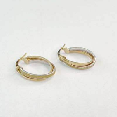 boucles d'oreilles créoles bicolores, or et argent, sur un fond blanc