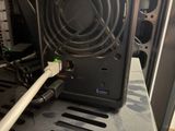 a white cable connected to a black computer case