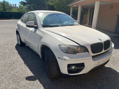 une photo d'un SUV BMW blanc garé sur un parking