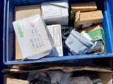 a blue box filled with assorted items on the street