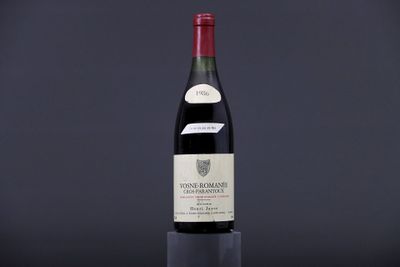 the bottle of wine is sitting on top of a glass