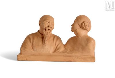 a clay sculpture of a man and a woman sitting on a bench