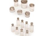 an assortment of silver and glass salt and pepper shakers on a white background