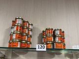 many jars of food sitting on a shelf in a store
