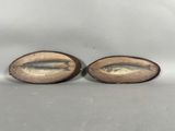 a pair of antique brass fish figurines on wooden bases