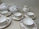 a table with a bunch of plates and cups and saucers on it