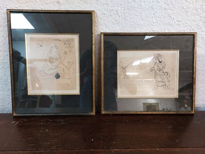 two framed drawings of a man and a woman sitting on a bench
