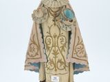 figurine of a woman holding a bird on a pedestal